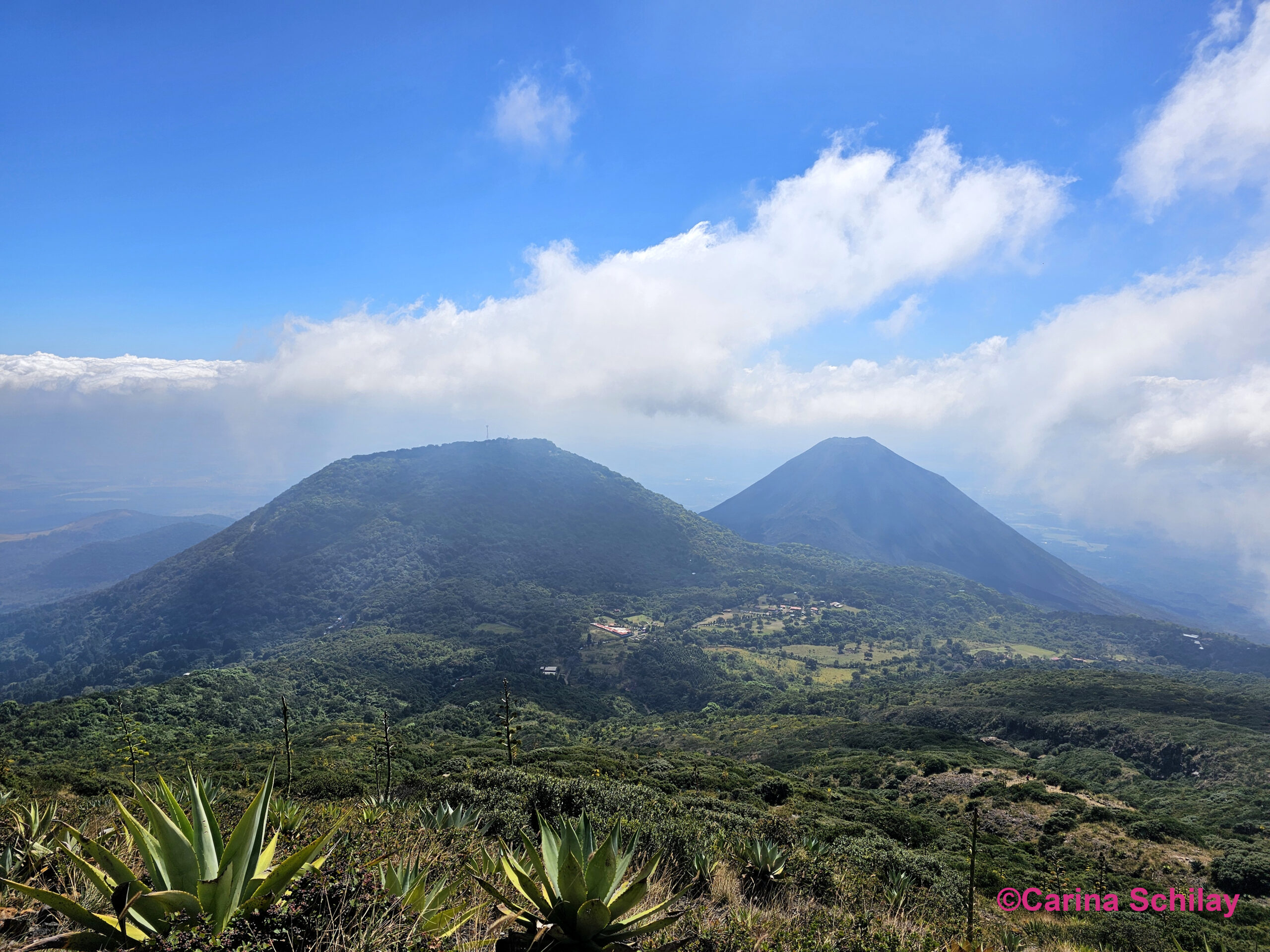 Der Vulkan Izalco im Hintergrund, eingefangen auf dem Weg zum Gipfel des Santa Ana Vulkans, umrahmt von der üppigen Vegetation El Salvadors.